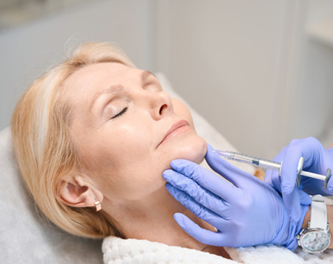 Mature woman receiving a medical cosmetic facial injection.